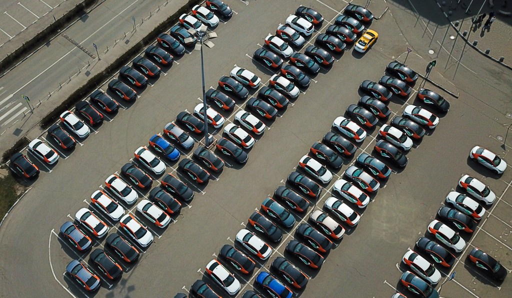 An overhead view of a parking lot full of car-sharing vehicles