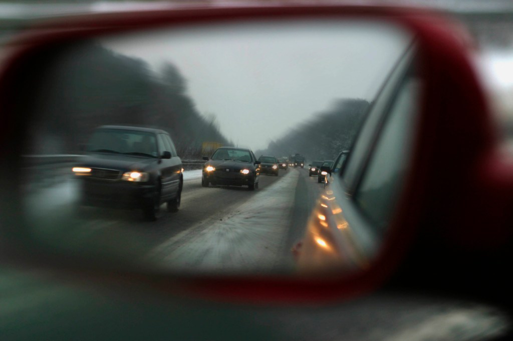 A side mirror view of Driving in the snow. |