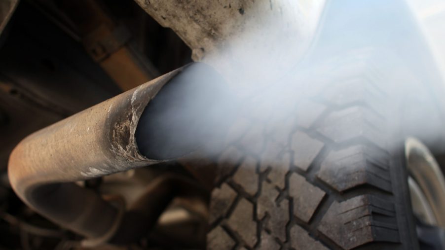 Exhaust smoke coming out of a tailpipe. | Getty Images