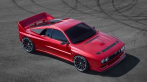 The red EVO37 sits on tarmac with tire tracks from donuts behind