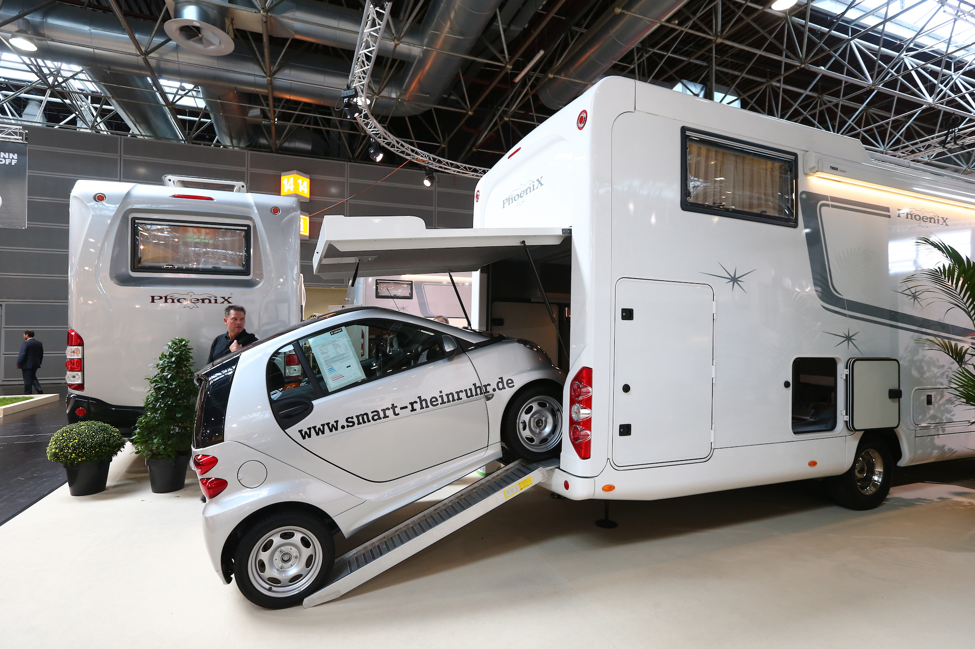 A SmartCar on a ramp leading into a toy hauler motorcoach at Caravan Salon Duesseldorf expo in Germany on September 4, 2014