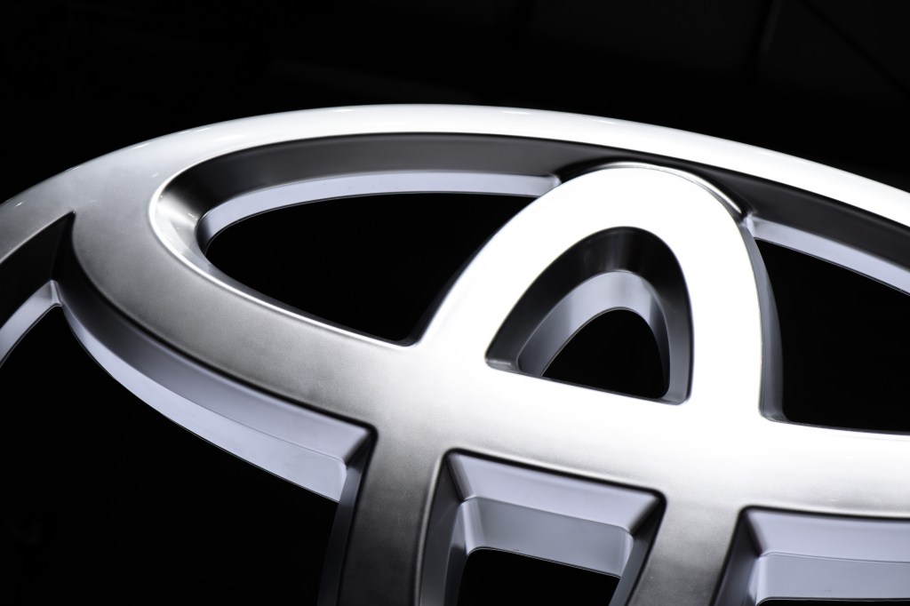 A closeup of a chrome Toyota logo badge