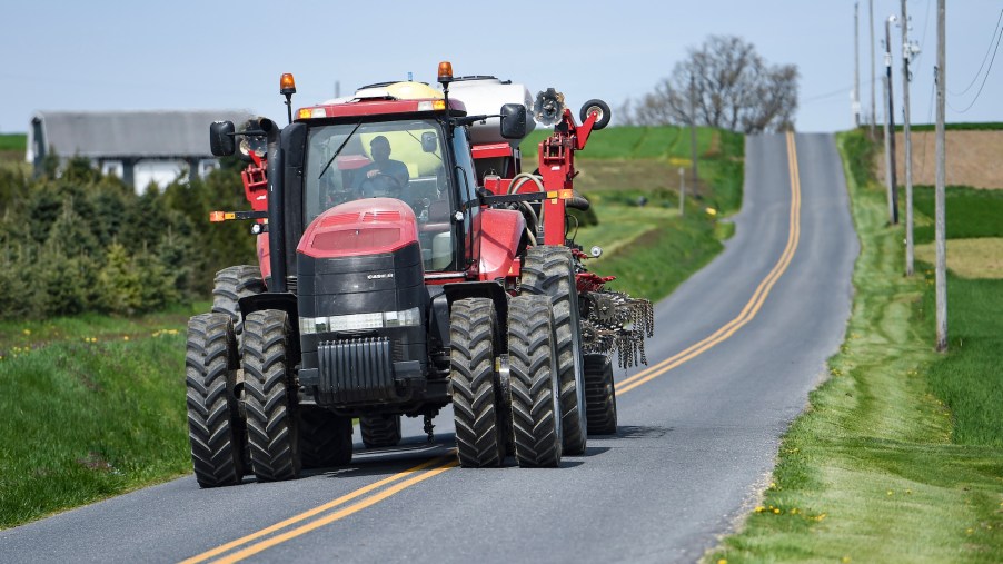 David Wolfskill drives a Case tractor pulling a corn planter on a street outside his Pennsylvania farm
