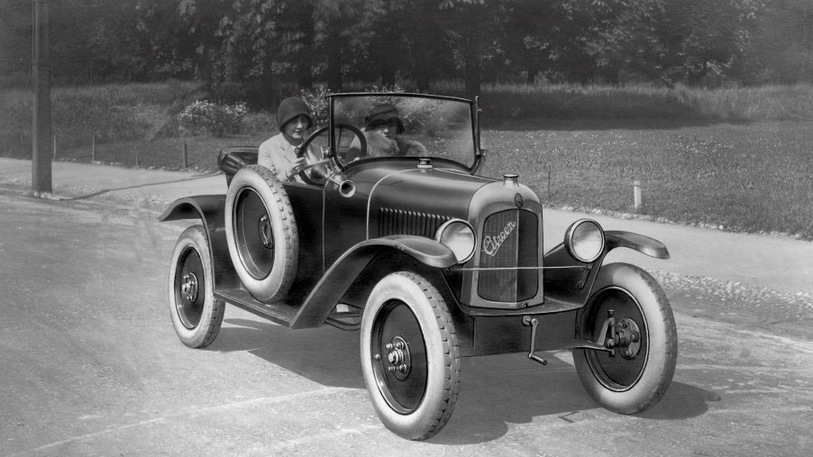 A black-and-white photo of two women driving in a Citroen car circa 1920-30