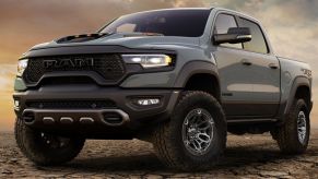 2021 Ram 1500 TRX is parked on gravel with a wide aggressive stance