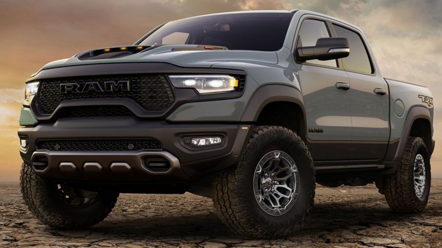2021 Ram 1500 TRX is parked on gravel with a wide aggressive stance