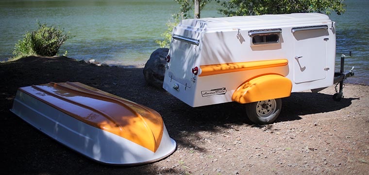 The American Dream in sherbert orange by a lake with the roof boat off