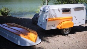 The American Dream in sherbert orange by a lake with the roof boat off