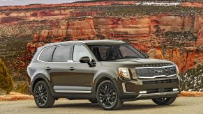 A bronze Kia Telluride in a canyon at sunset