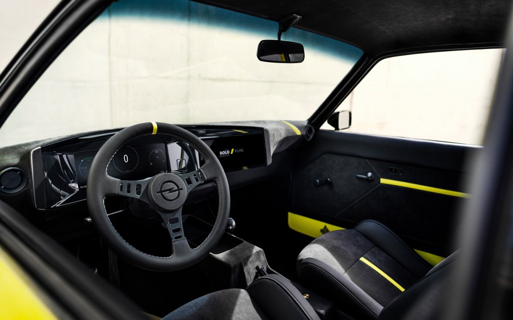 The interior of the Opel Manta GSe with yellow accents on the seats and doors