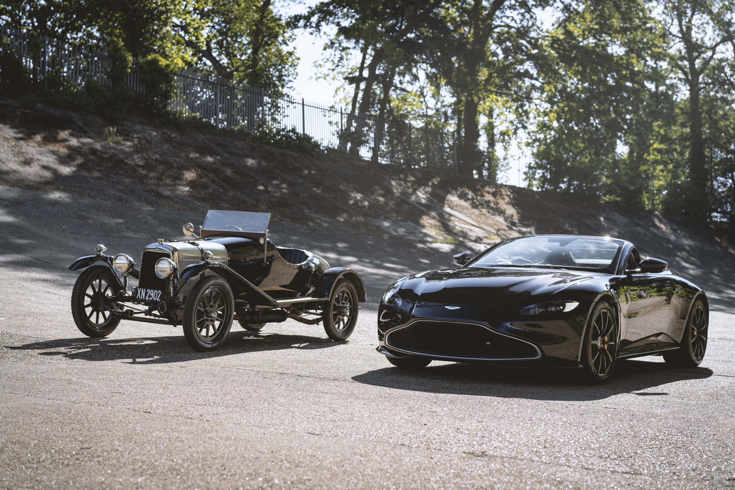 The black 1921 Aston Martin A3 next to the black Q by Aston Martin Vantage Roadster at the Brooklands circuit