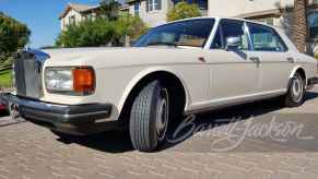 1989 Rolls-Royce Silver spur in profile parked in front of a house