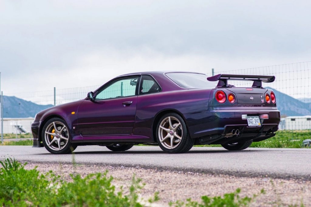The rear 3/4 view of a a 1999 R34 Nissan Skyline GT-R V-Spec on a road