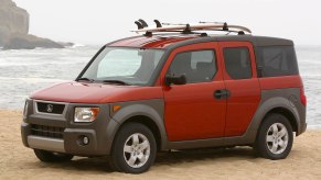 An orange 2004 Honda Element at the beach, the Element is one of the best cheap used SUVs under $5,000