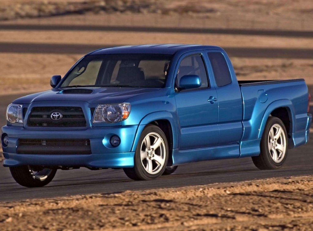 A blue 2005 Toyota Tacoma X-Runner goes around a corner of a desert racetrack