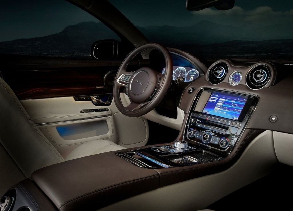 The brown-and-beige-leather-upholstered driver's side front interior of a 2012 Jaguar XJ