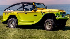 A yellow-gray-and-green 2016 WaterCar Panther on a field by a body of water