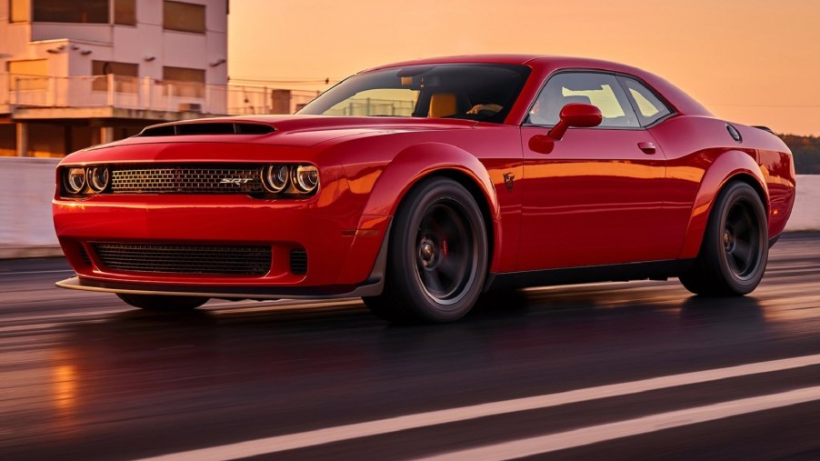 A red 2018 Dodge SRT Demon driving down a prepped dragstrip