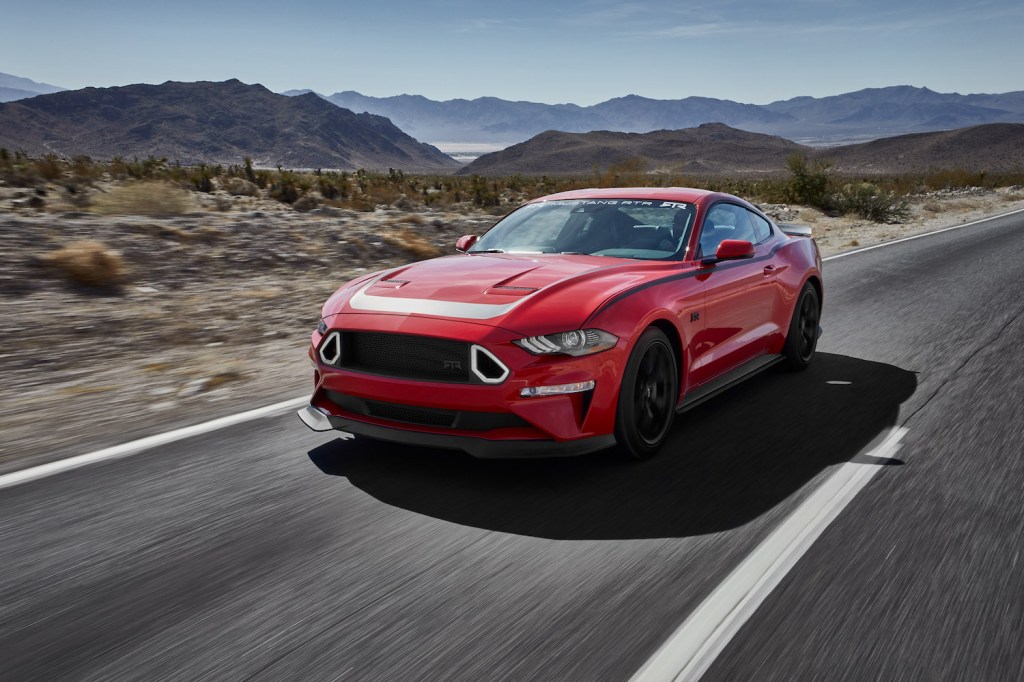 A red 2018 Ford Mustang driving