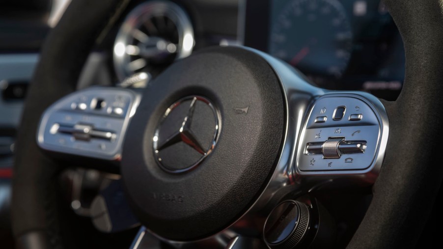 A close-up of a 2020 Mercedes-Benz CLA 45 sedan's black and silver ​steering whee