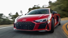 A red 2021 Audi R8 driving, the R8 is one of the best new sports cars with all-wheel drive