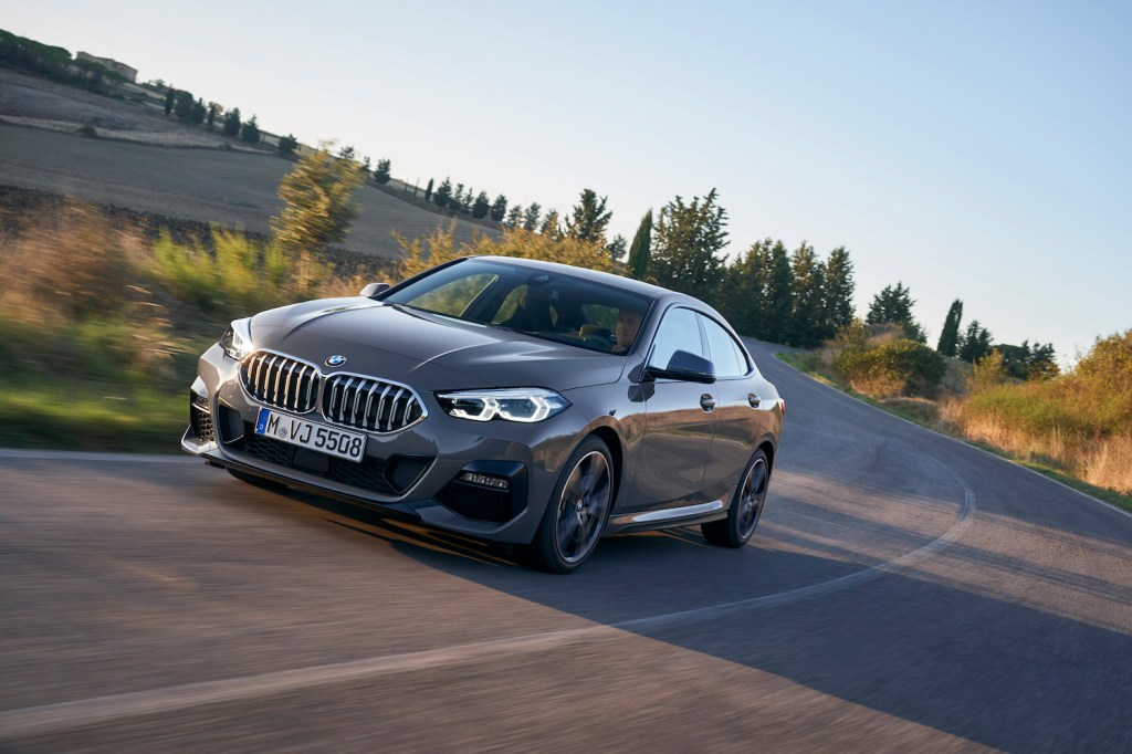 A grey 2021 BMW 2 Series Gran Coupe driving, the 2021 BMW 2 Series Gran Coupe is one of the best new luxury cars according to Consumer Reports