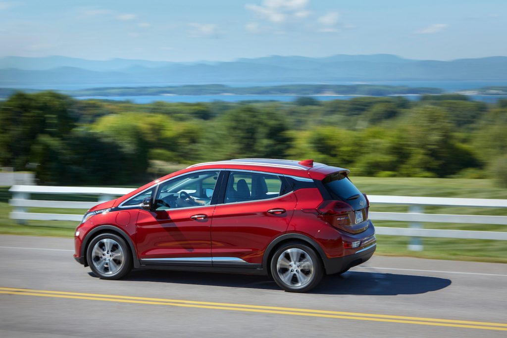 A red 2021 Chevrolet Bolt EV driving, the 2021 Chevrolet Bolt EV is one of the cheapest new electric cars of 2021