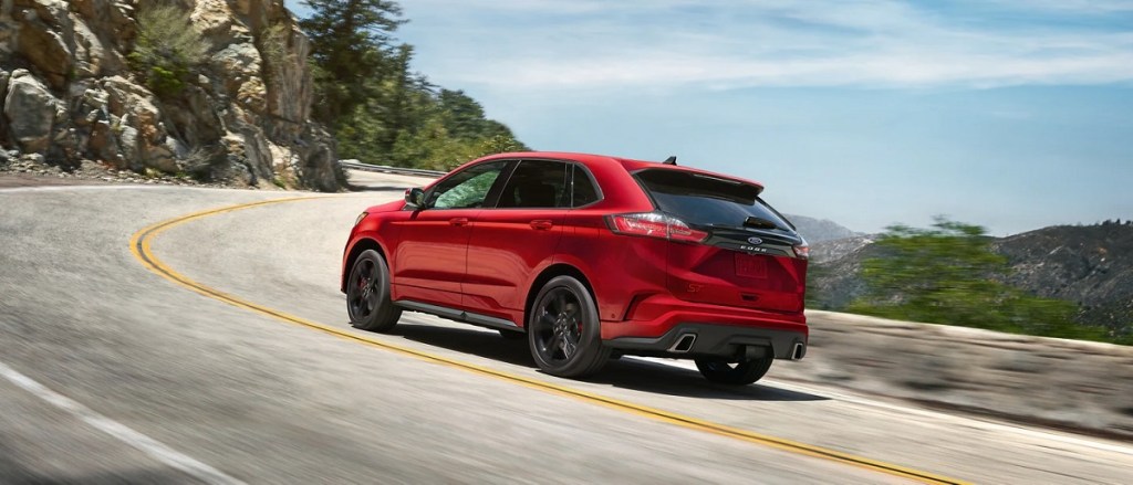 A red 2021 Ford Edge races down the highway.