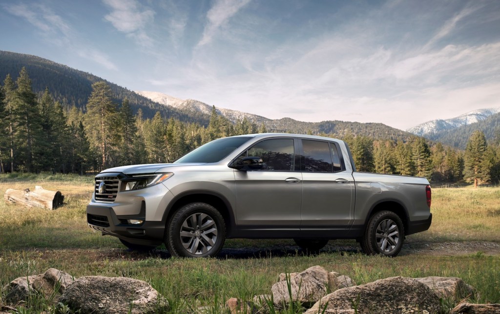 A silver 2021 Honda Ridgeline parked in the wilderness, the 2021 Honda Ridgeline is one of the best new pickup trucks under $40,000