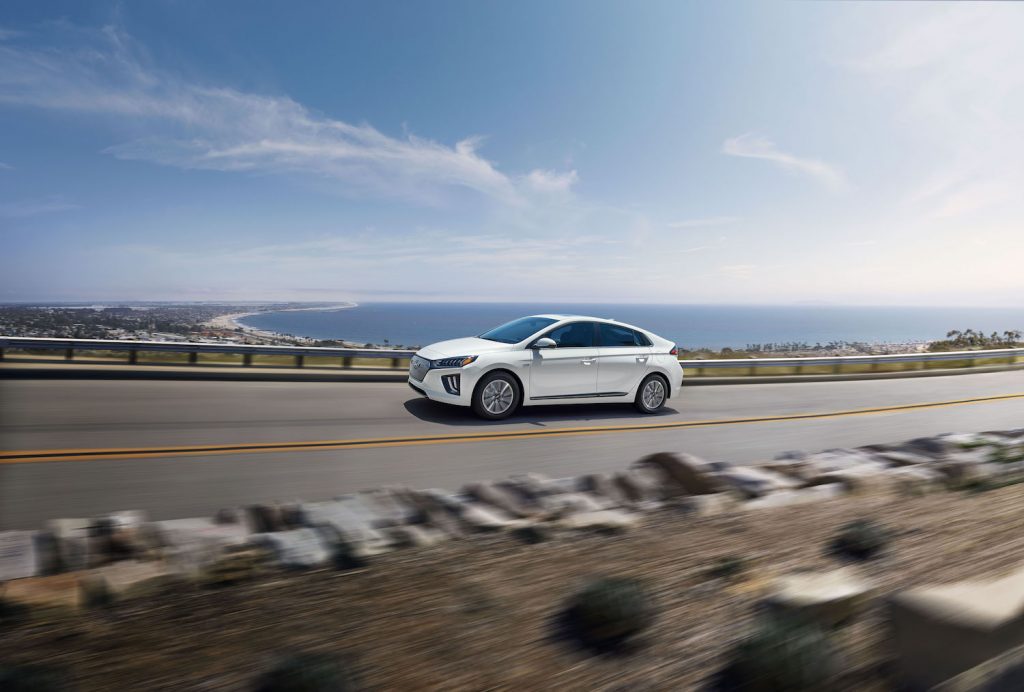 A white 2021 Hyundai Ioniq Electric driving, the 2021 Hyundai Ioniq Electric is an affordable electric car