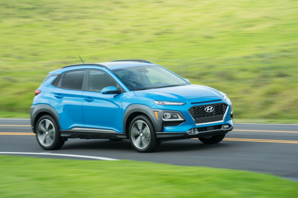A blue 2021 Hyundai Kona driving, the 2021 Hyundai Kona is one of the most affordable new SUVs under $30,000