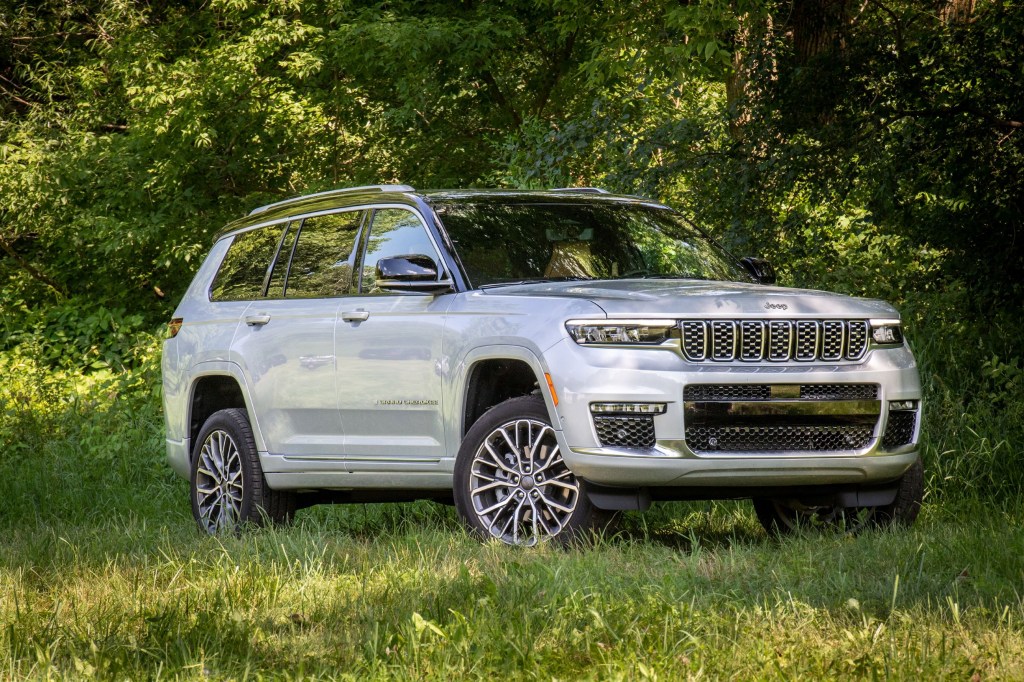 A white 2021 Jeep Grand Cherokee L Summit Reserve parked in the forest shade