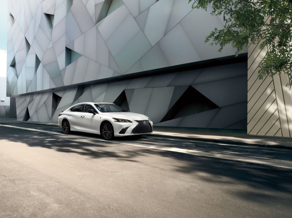 A white 2021 Lexus ES driving down an empty street