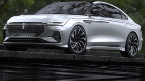 The silver 2021 Lincoln Zephyr Reflection Concept parked on top of a flight of black stone steps