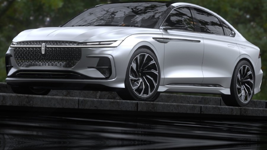 The silver 2021 Lincoln Zephyr Reflection Concept parked on top of a flight of black stone steps