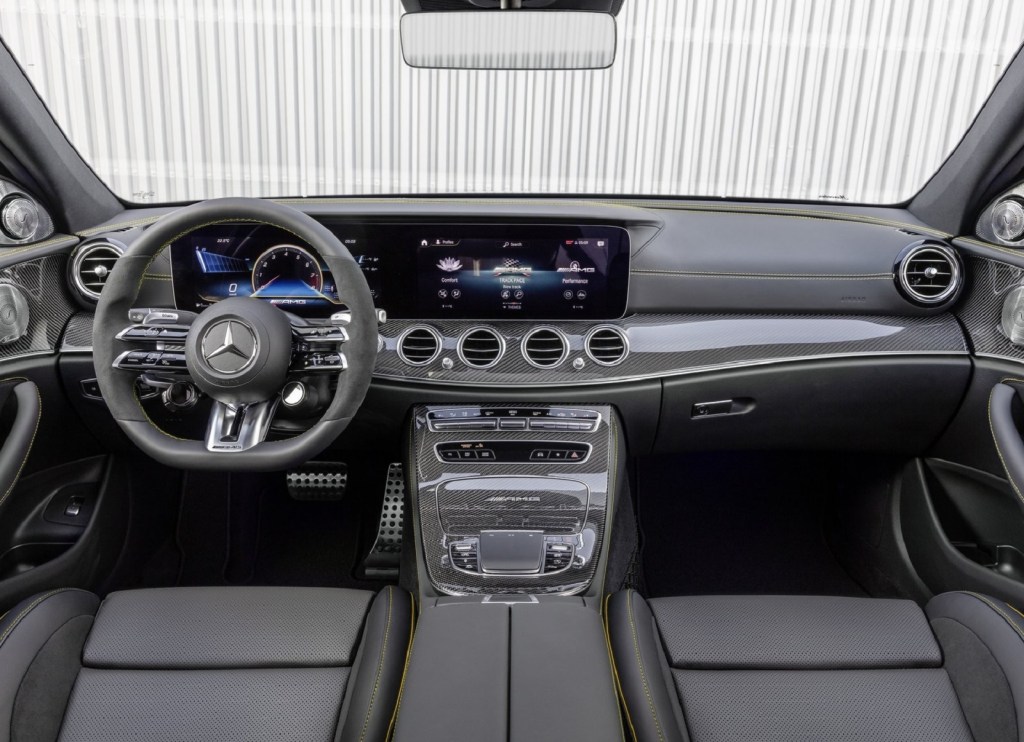 The black-leather-upholstered front seats and carbon-fiber-trimmed dashboard of a 2021 Mercedes-AMG E63 S