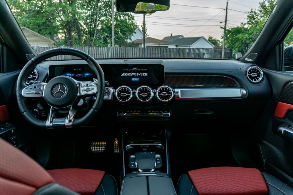 The black-and-red-leather front seats and the black dashboard of a 2021 Mercedes-AMG GLB 35