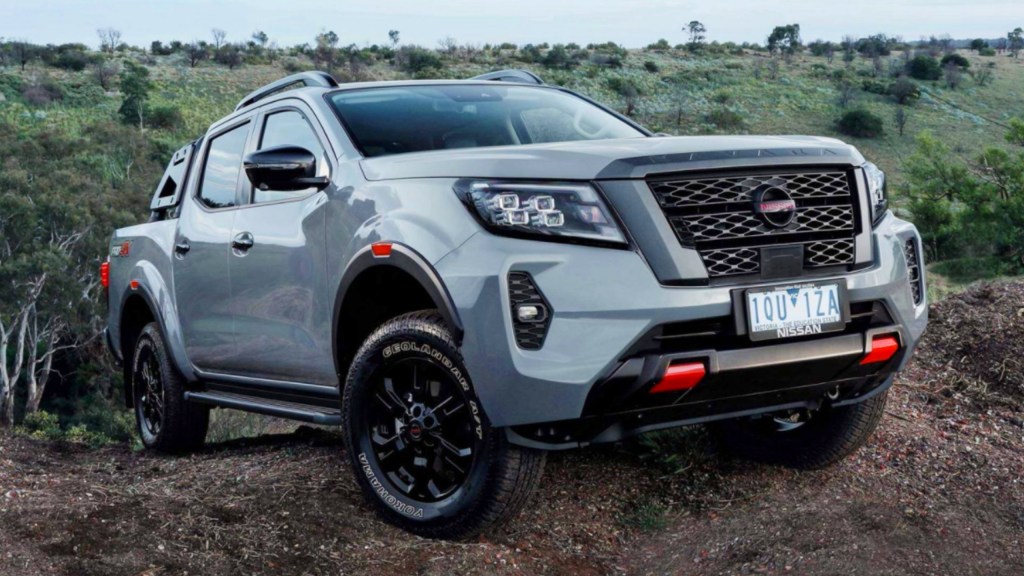 A gray Nissan Navara Pro-4X pickup truck is driving off-road.