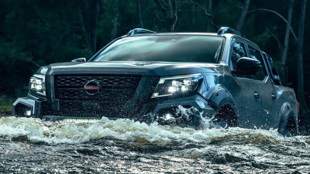 A Nissan Navara PRO-4X Warrior is driving through the water. 