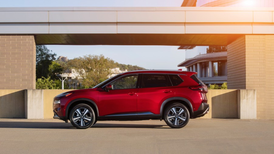 A red 2021 Nissan Rogue parked with the sun shining on it