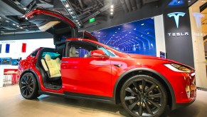 A red 2021 Tesla Model X at a car show, the Model X is the best luxury SUV for tall drivers