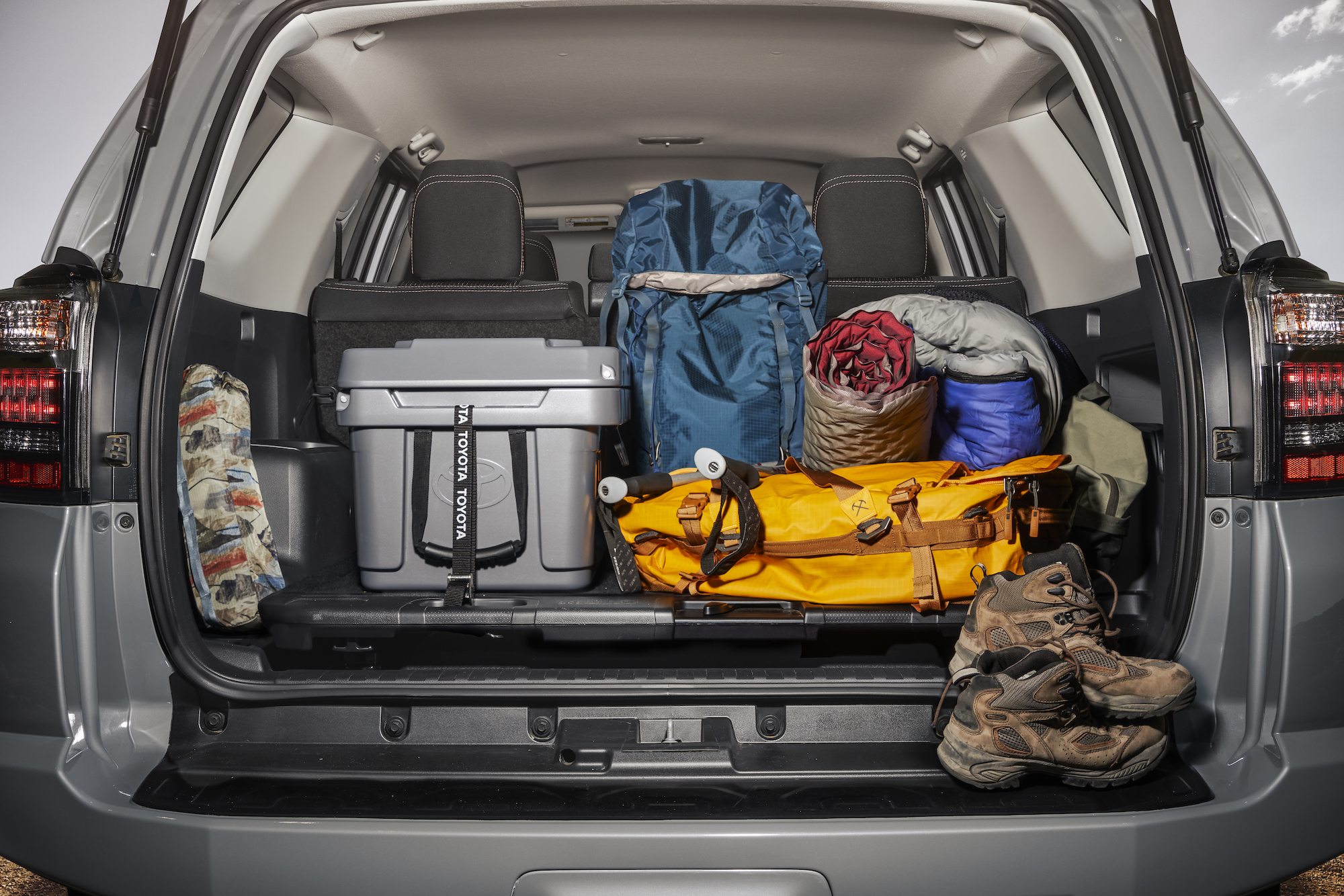 A 2021 Toyota 4Runner SUV's tailgate is open to reveal hiking equipment
