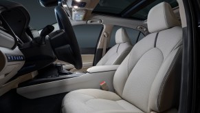 The gray ventilated front seats of a 2021 Toyota Camry XLE midsize sedan