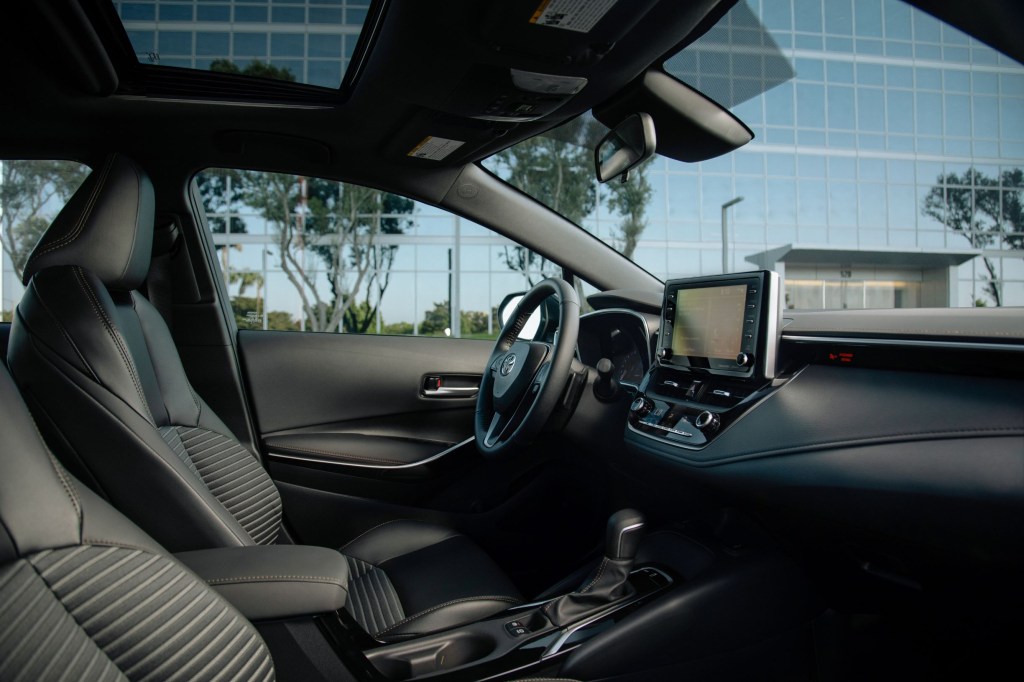 A side view of the black front seats and dashboard of a 2021 Toyota Corolla XSE Apex Edition