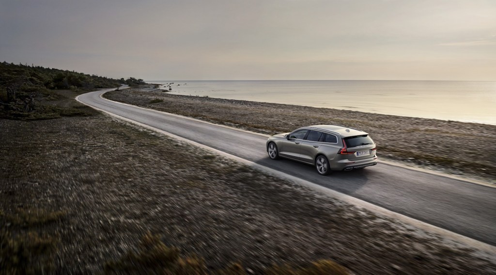 A 2021 Volvo V60 driving down an empty read, the V60 is one of the best plug-in hybrids, TrueCar reports