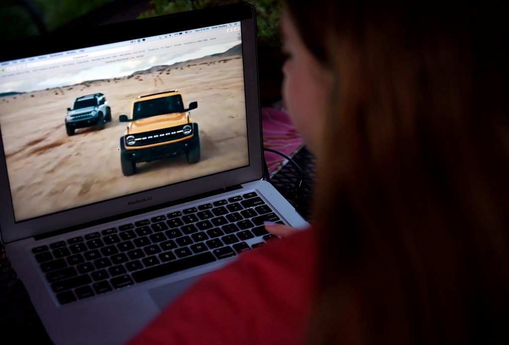 A person watching the 2021 Ford Bronco World Premier on a laptop.