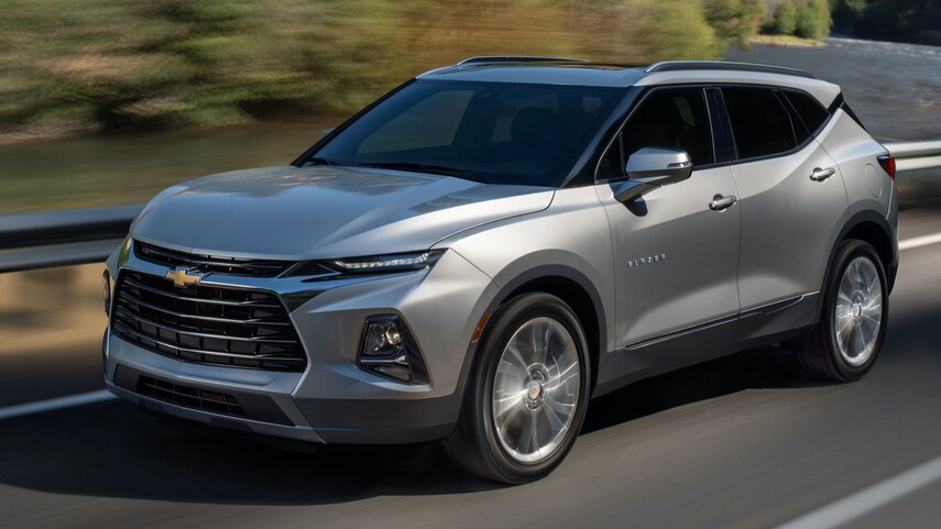 A silver 2022 Chevy blazer driving down the road 