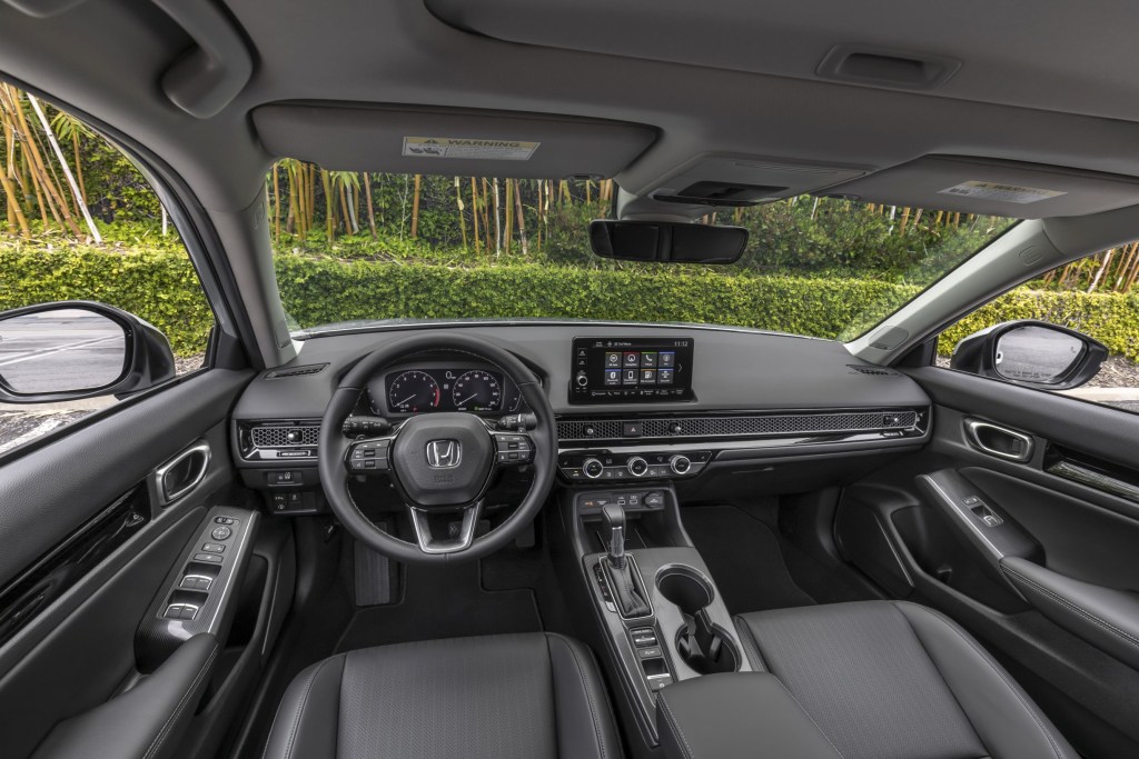 The black front seats and dashboard of a 2022 Honda Civic Sedan Touring
