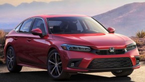 A red 2022 Honda Civic Sedan parked on a mountain road