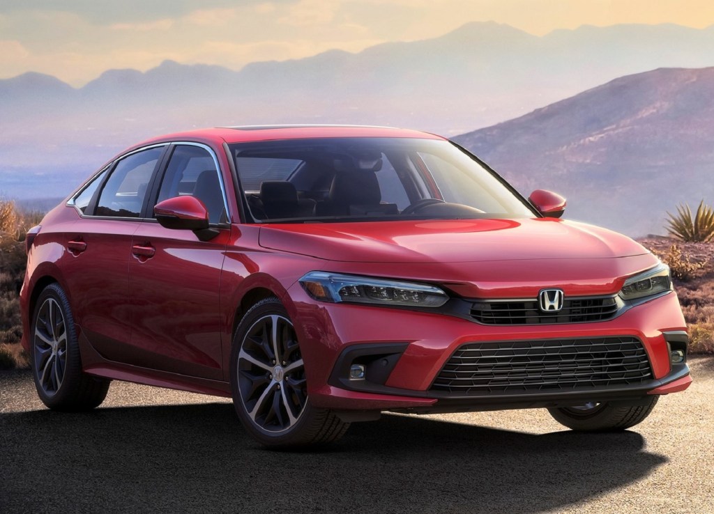 A red 2022 Honda Civic Sedan parked on a mountain road